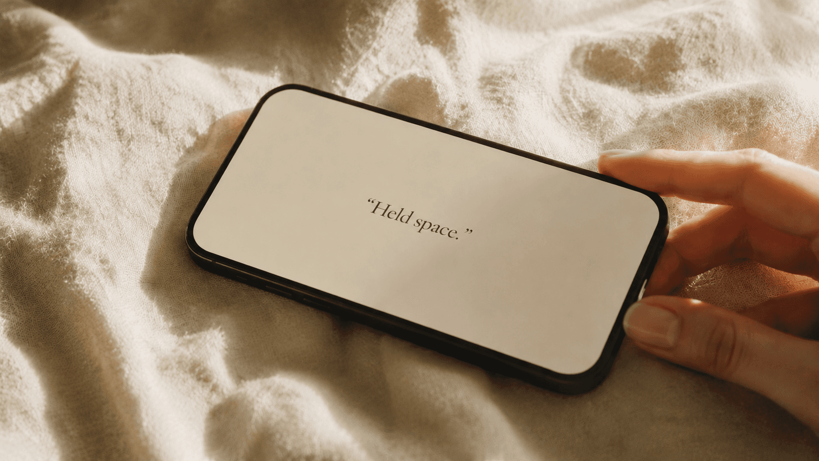Editorial phone mockup showing the quote 'Held space.' on cream linen.